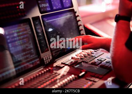 Light board operator working with control console. Selective focus. Stock Photo