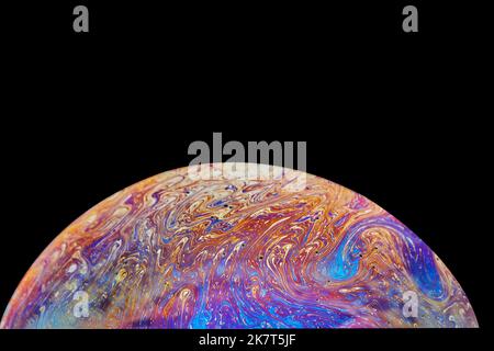 Virtual reality space with abstract multicolor psychedelic planet. Closeup Soap bubble like an alien planet on black background Stock Photo