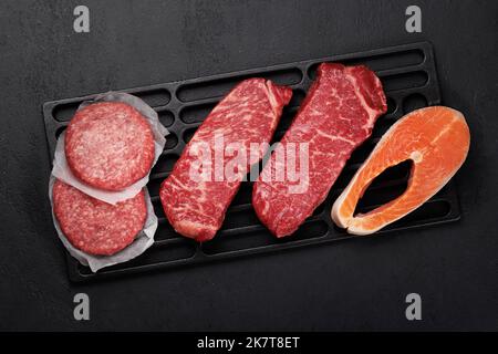 Various raw meat and fish. Steaks, burgers and salmon. Flat lay Stock Photo