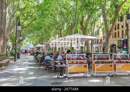 Palma de Mallorca, Spain - June 22, 2022: entrance of La Rambla with tourists and locals walking. this is a popular pedestrian area 1.2 kilometer-long Stock Photo