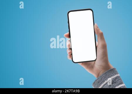 Female hand holding a smartphone with blank screen, technology and communication concept, POV shot Stock Photo