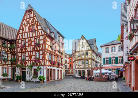 Mainz, Germany - August 27, 2022: Traditional German half timbered houses at Mainz city centre. Cobble stone street. Stock Photo