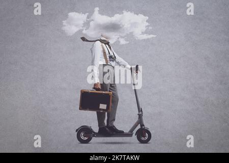 Vintage style man holding a suitcase and riding an electric scooter, his head is in a cloud Stock Photo
