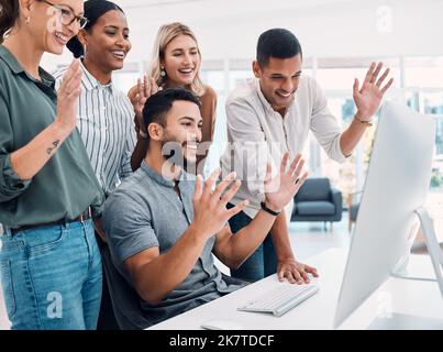 Video conference, business and employees with wave while talking on a computer together at work. Happy, corporate and young group of marketing Stock Photo