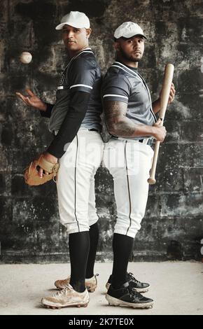 Baseball, sports and team with a man athlete and player standing back to back in uniform for training. Sport, teamwork and uniform with a portrait of Stock Photo