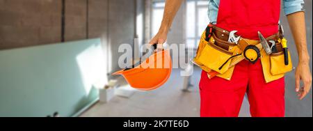 Cropped shot of young repairman wearing a tool belt with various tools Stock Photo
