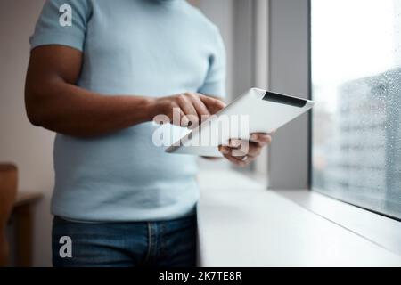 Im trying something new. an unrecognisable businessman using a digital tablet. Stock Photo