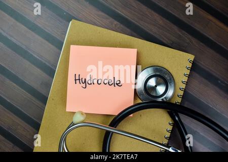 Concept of Hydrocele write on sticky notes isolated on Wooden Table. Stock Photo