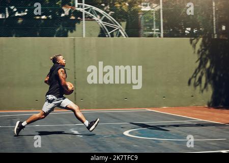 Young black man, basketball fitness outdoor training and running on court. Athletic sport wellness exercise, healthy lifestyle vision and professional Stock Photo