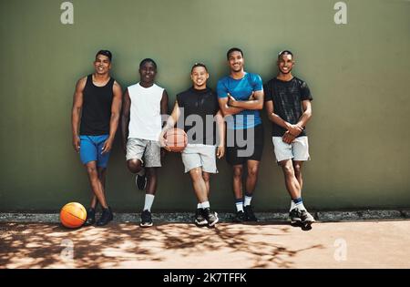 Sports, basketball and team at court training for a game, match or competition with a smile. Portrait of athletes, workout and diverse group of men Stock Photo