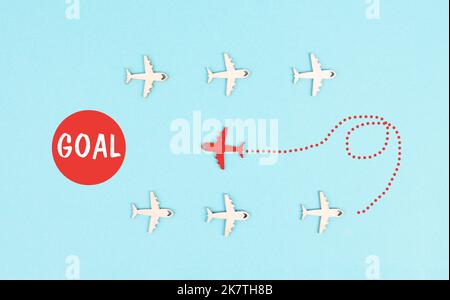 Red airplane is following his goal, leadership, courage and winner concept, standing out from the crowd, positive mindset for success in business Stock Photo