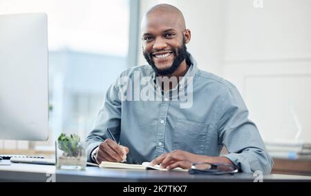 Ive got all my goals on plan. a handsome young businessman sitting alone in the office and writing in his notebook. Stock Photo
