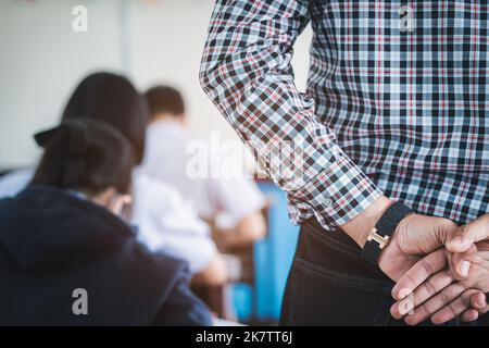 The teacher controls the exam room for students to take the exam in the classroom Stock Photo