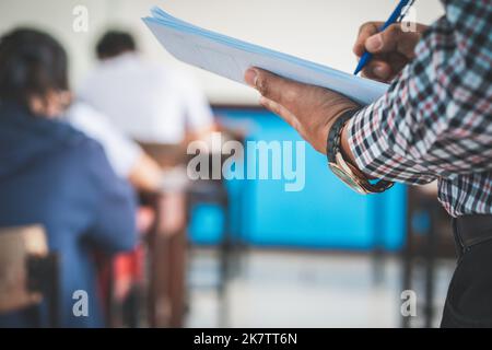 The teacher controls the exam room for students to take the exam in the classroom Stock Photo