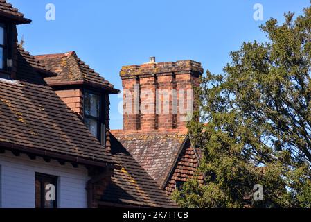 Old style brick chimney with ceramic pot on the top in a rural village in Hampshire, England. Stock Photo