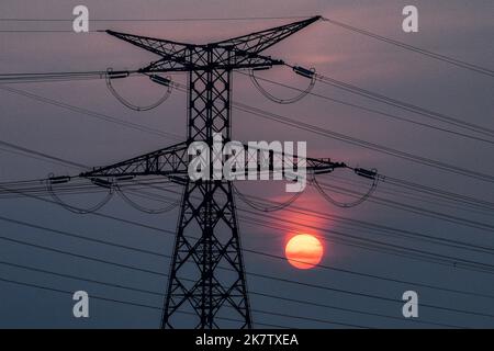 High voltage power line, transmission tower at sunset Stock Photo