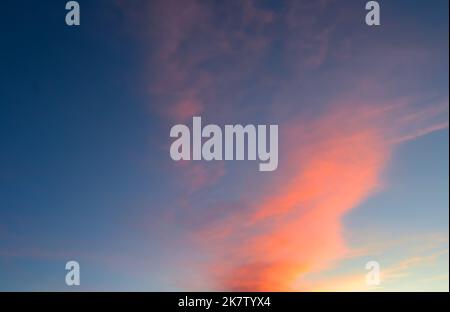 Colorful Sunset. Real amazing panoramic sunrise or sunset sky with gentle colorful clouds. Beautiful sunrise background. Blue, red, yellow colors Stock Photo