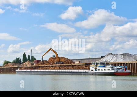 Large barge “Le Condor” loaded with wood in the river port of Villefranche sur Saone, handling and loading of wooden trunks for a paper mill in Tarasc Stock Photo