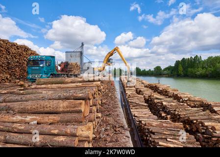 Large barge “Le Condor” loaded with wood in the river port of Villefranche sur Saone, handling and loading of wooden trunks for a paper mill in Tarasc Stock Photo