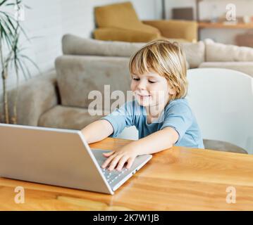 child laptop computer technology home boy son man education homework kid learning internet childhood student sitting connection using online Stock Photo