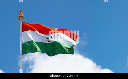 Large Indian flag or flag of India waving in front of blue sky during sunny day, space for text Stock Photo