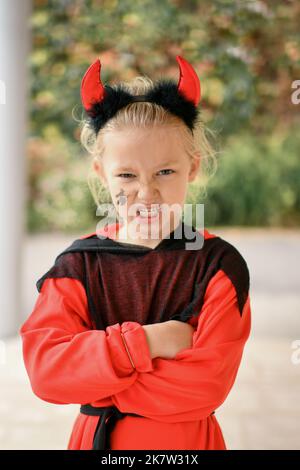 Scary girl dressed as a devil with horns Stock Photo