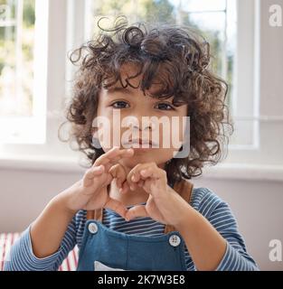 An age before jaded pessimism. Portrait of an adorable young boy relaxing in his bedroom at home. Stock Photo