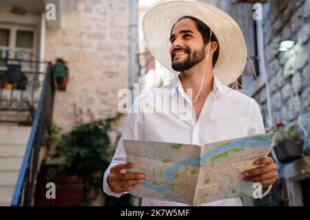 Happy young tourist man having fun and travelling on summer vacation Stock Photo