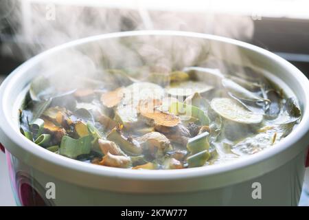 Thai Herbs are boiled in an electric pot include many types such as ginger, galangal, lemongrass, kaffir lime, lemon. Concept of herbal for  used to s Stock Photo