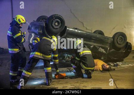 Austrian firemen tend to an accident casualty at a staged traffic ...