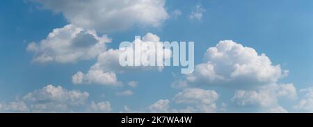 Bright heap clouds on blue sky, panoramic landscape of clouds Stock Photo