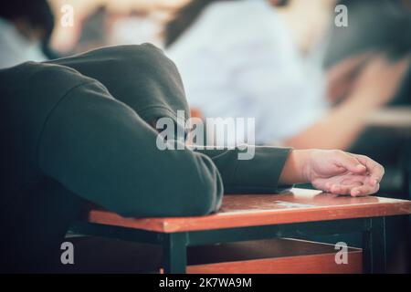 Tired students sleeping during exam test in classroom Stock Photo