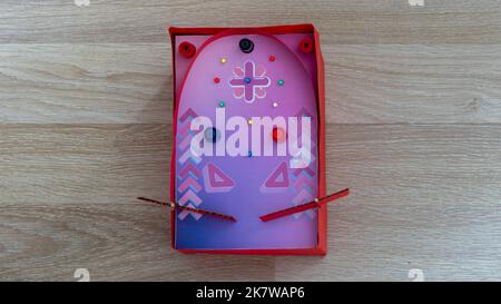 Handmade cardboard pinball machine made by a child easily. Make a