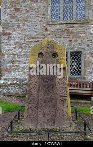 The West View of the Aberlemno 2 Sculptured Stone in the Kirkyard of the local church, with its Celtic Cross carved into a Red Sandstone Slab.