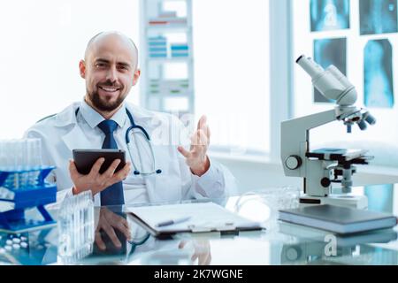 smiling young scientist works in a laboratory. Stock Photo