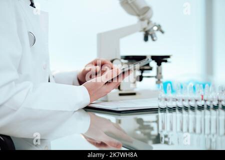 scientist using a digital tablet while working in the lab. Stock Photo