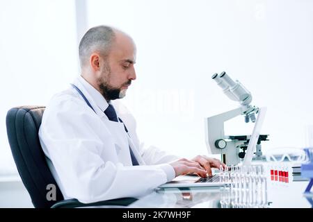 scientist using a laptop in a medical lab. Stock Photo