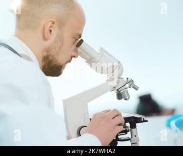 scientist using a microscope in the lab. side view. Stock Photo