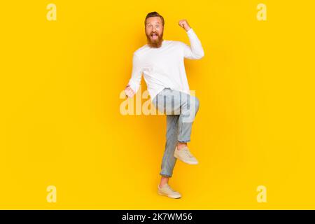 Full body photo of hooray beard man yell wear white shirt jeans boots isolated on yellow color background Stock Photo
