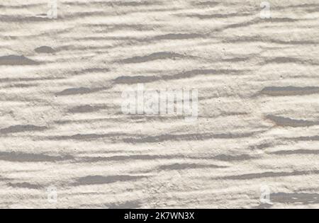 White rugged painted wooden wall with rough textures and shadows. Plain background with copy space. Stock Photo