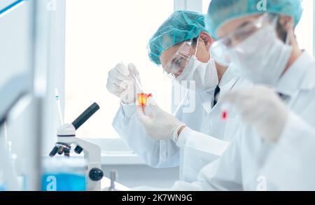 close up. group of laboratory technicians conduct testing in the laboratory . Stock Photo
