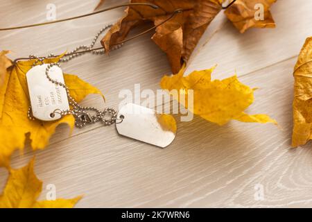 dry autumn leaves and a military tag. Stock Photo