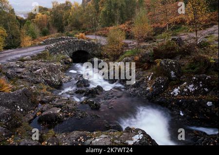 Ashness Bridge over Barrow Beck in an autumnal Borrowdale, Lake District, UK Stock Photo