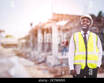 African architects engineer man with tablet work together in the inside the construction building site Stock Photo