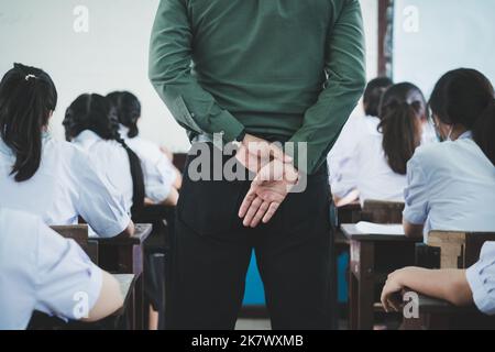 The teacher controls the exam room for students to take the exam in the classroom Stock Photo