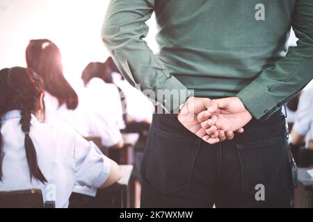 The teacher controls the exam room for students to take the exam in the classroom Stock Photo