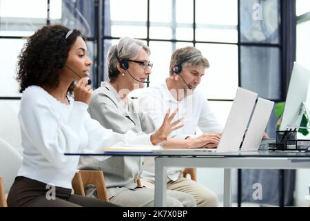Call center agent with headset working on support hotline Stock Photo