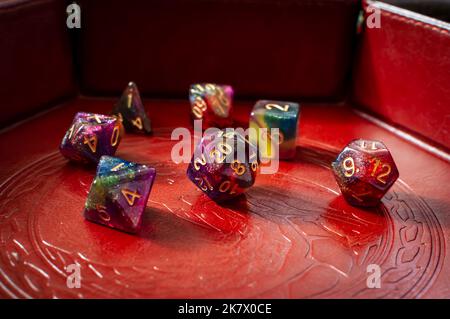 Close-up image of a set of colorful role-playing gaming dice in a brown leather dice tray Stock Photo