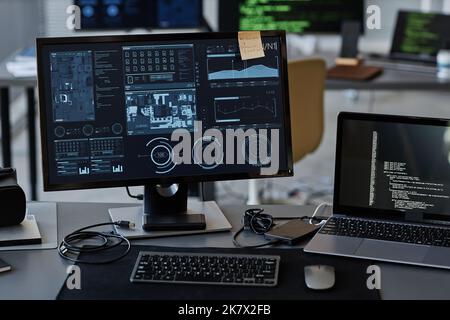 Background image of several computer screens with data and control panels on desk in IT company office Stock Photo