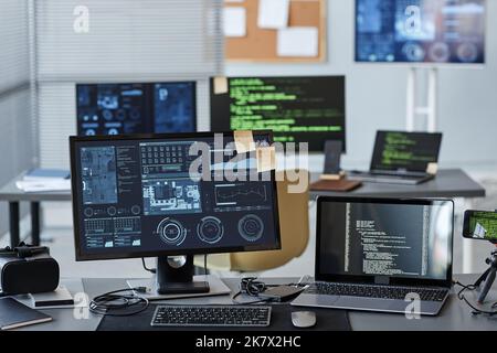Background image of several computers with data and control panels in IT company office, copy space Stock Photo